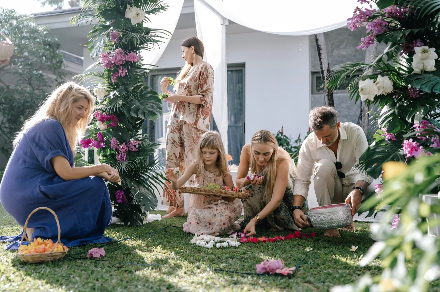 Family and guests preparing flower petals for a private celebration ceremony
